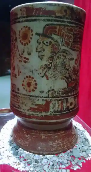 Cup with a face and solar discs composed of circles